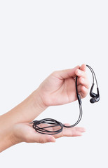 A woman hand holding earphones