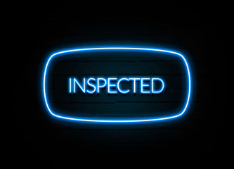 Inspected  - colorful Neon Sign on brickwall