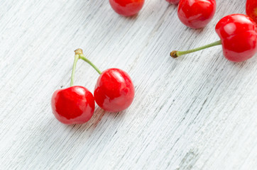 Cherries on a white background. Red berries with green twigs.