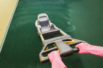 Dry cleaner's employee hands foaming, rubbing and cleaning a carpet with professionally disk machine. Before and after. Early spring regular cleanup. Commercial cleaning company concept.