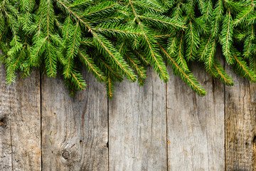 Christmas tree spruce branches on old rustic boards, festive decoration of wooden table, background with copy space