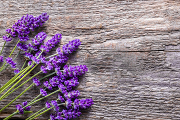 Lavender flowers, background, bouquet on rustic wooden surface, overhead
