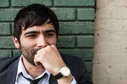 Man in a suit wearing a tie looking away from camera