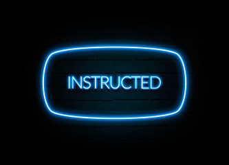 Instructed  - colorful Neon Sign on brickwall