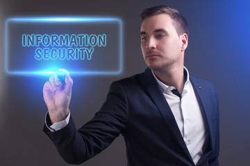 The concept of business, technology, the Internet and the network. Young businessman showing inscription: Information security