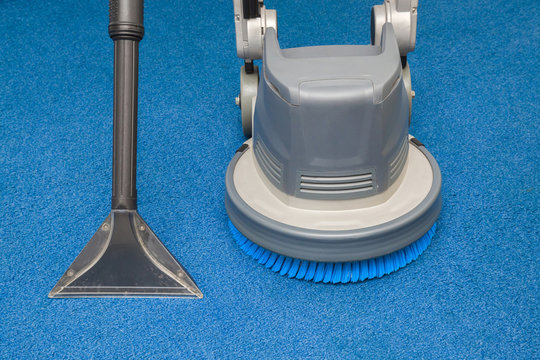 Disk machine and vacuum cleaner nozzle for carpets professionally cleaning with extraction method. Early spring regular cleanup. Commercial cleaning company concept.