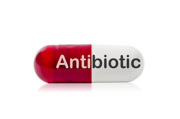 Red and white pills capsule with antibiotic.