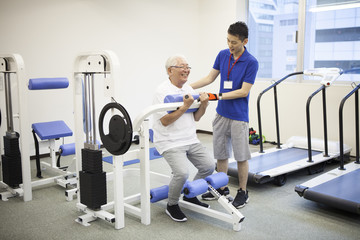 Fototapeta na wymiar The trainer teaches training methods to old men
