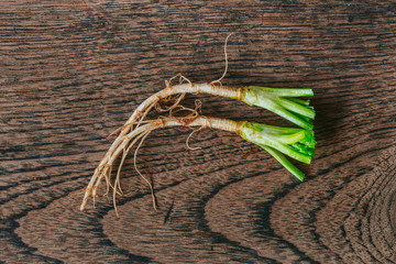 Coriander or Cilantro root wood background