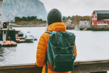 Woman traveler enjoying Norway village landscape Travel Lifestyle concept adventure winter...