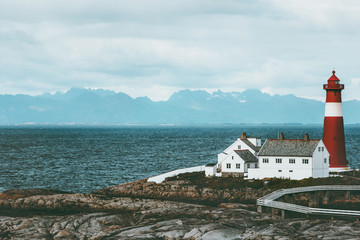 Fototapeta na wymiar Tranoy Lighthouse Norway Landscape sea and mountains on background Travel scenery scandinavia