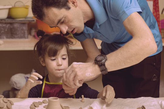 little girl in a pottery workshop