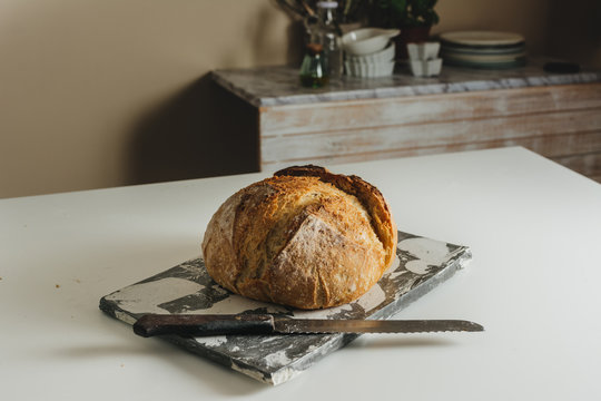 freshly baked rustic bread, on marble table,