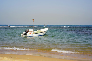 Fototapeta premium Boat with fishing nets on the beach