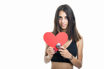 Fit girl holding red heart shape and stepthoscope