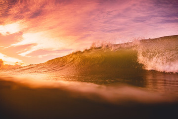 Ocean wave at sunset or sunrise. Wave and with warm sunset or sunrise colors