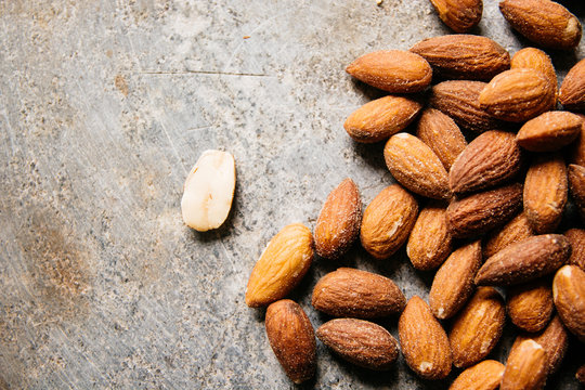 Almond seeds on a stone surface from above