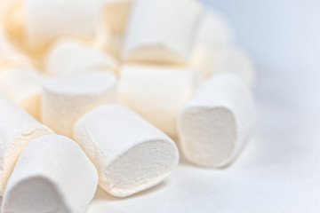 Close up background of many white fluffy marshmallows