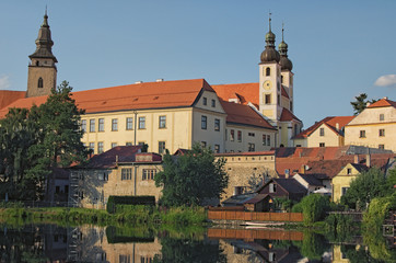 Fototapeta na wymiar Telc is a town in southern Moravia in the Czech Republic. Telc Castle and city reflected in lake. A UNESCO World Heritage Site