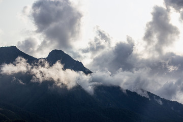 the top of the mountain in the clouds