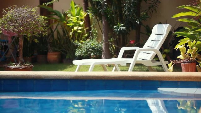 Tropical paradise. Sunbed lounger near the swimming pool. 1920x1080