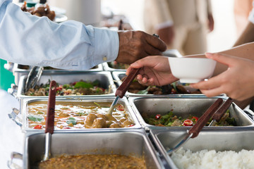people group catering buffet food indoor in restaurant,Hands of People are scooping food buffet.