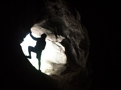 Silhouette of man at the entrance to the cave
