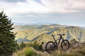 Fototapeta na wymiar Mountain bike sunset silhouette on forest trail, inspiring landscape