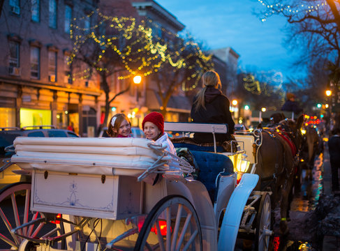 Family Horse Carriage Ride Through Decorated City