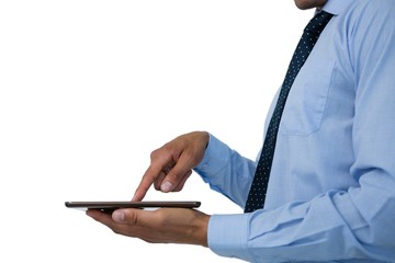 Mid section of  businessman using tablet 