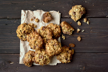 Oats cookies on paper, top view