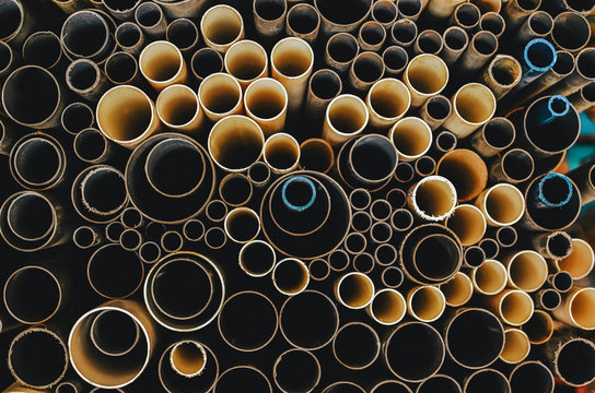 Bunch of stacked plastic pipes creates a pattern