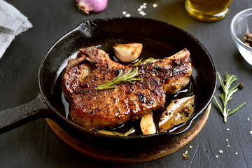 Fried pork steak in frying pan