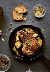Roasted pork steak in frying pan