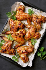 Roasted chicken wings on baking tray