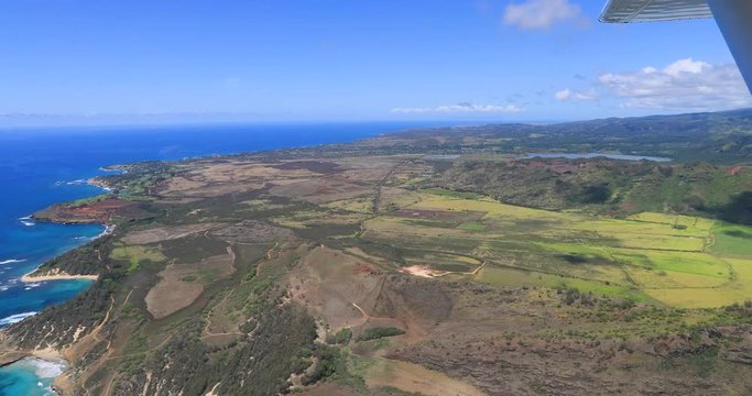Aerial Kauaii Hawaii coast POV from airplane. POV flying airplane. Kauai is the oldest Hawaiian Island. Garden Isle. Waimea Canyon State Park and Na Pali coast. Volcanic mountain geology.