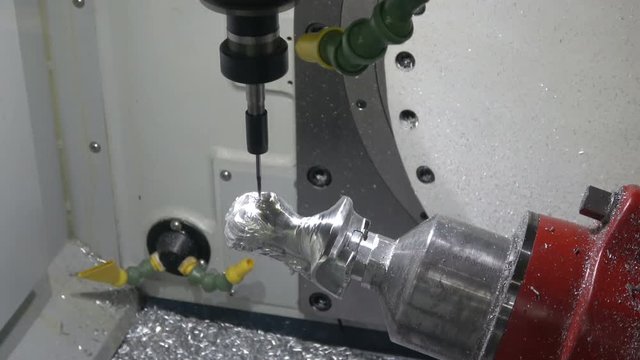 Full 5axis Spinner machine. Close up of metal processing
