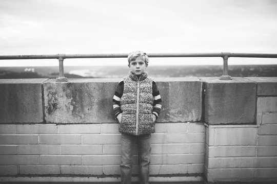 black and white portrait of a boy in an urban setting