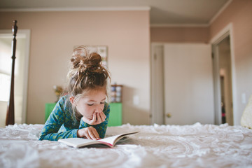 Girl reading on bed