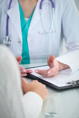 Doctor and patient, close-up of hands.  Physician talking about medical examination results....