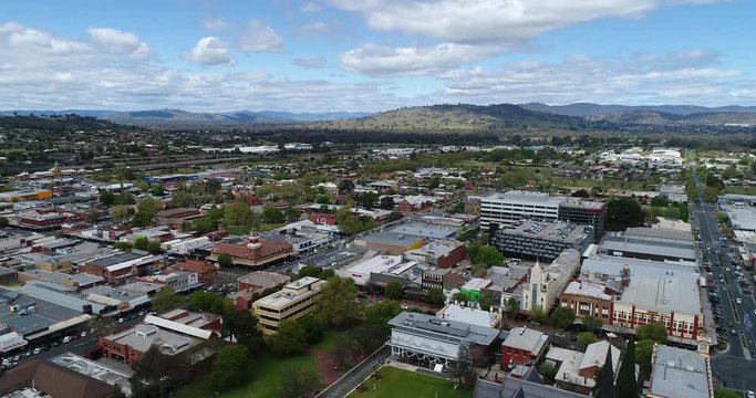 Albury regional NSW town centre around Town Hall and church in aerial descending footage.
