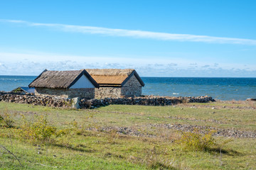 Fototapeta na wymiar Historic Bruddesta fishing village on the west coast of Swedish Baltic sea island Oland during early autumn. Oland is a popular tourist destination in Sweden during summertime.