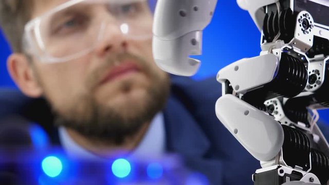 Engineer working in laboratory with the robot mechanism.

