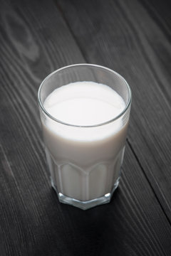 Milk glass on wooden table. Healthy eating concept