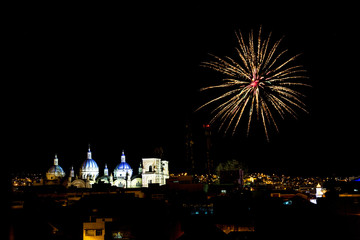 Fireworks over the domes of the New Cathedral in Cuenca, Ecuador. These are the famous view that are usually found on all travel brochures for the city. © mindstorm