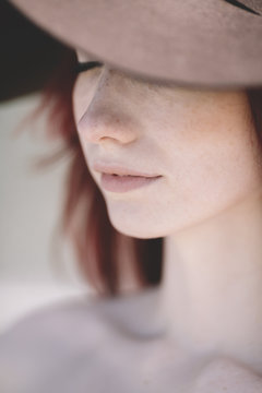 closeup of young dreaming woman with hat