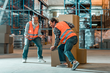 Fototapeta premium warehouse workers moving boxes
