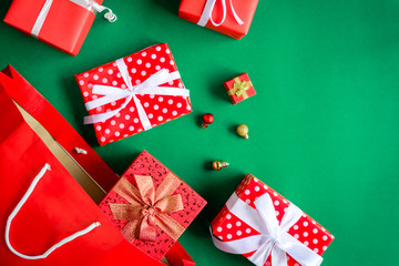 top view gift boxes in bag and shopping mall on the green table