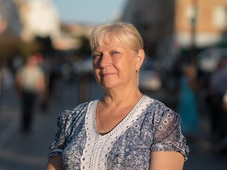 Portrait of beautiful aged woman in the park. Selective soft focus on eyes.