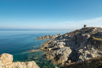Rocky coastline and Genoese tower at Punta Spano in Corsica